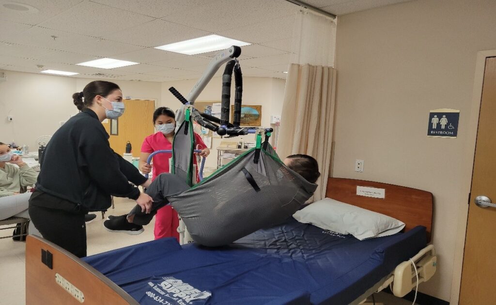CNA students practice safely transferring in CNA clinical training