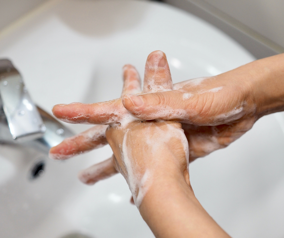 A CNA washing their hands